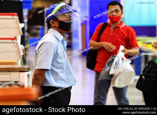 A Workers wearing a face shields as a preventive measure at an Jogja City Mall in Yogyakarta, Indonesia on May 30, 2020. The Indonesian Government is going a...
